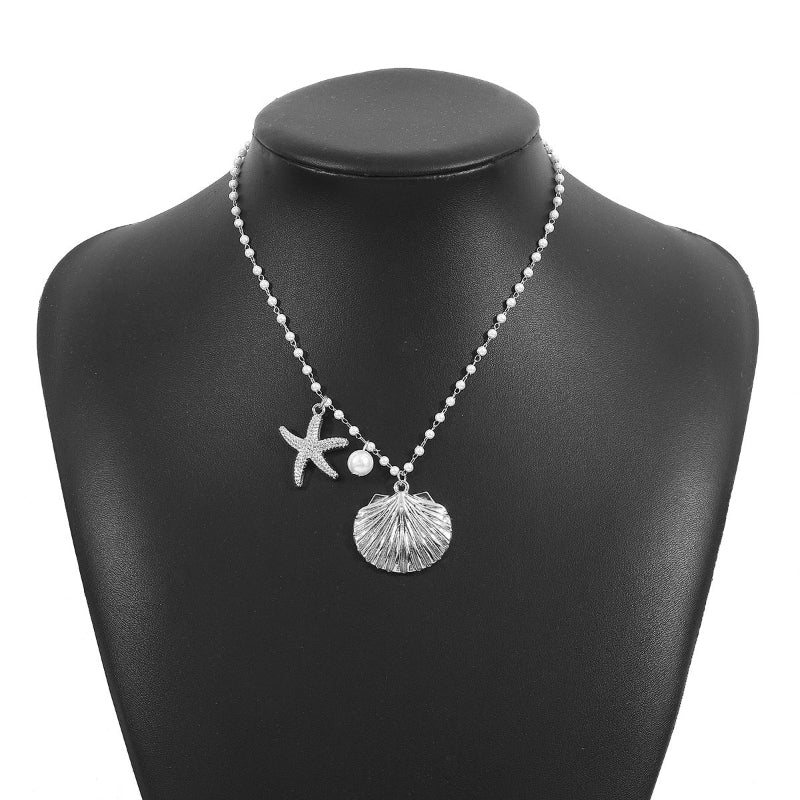 Necklace with starfish and shell pendant on a black mannequin bust