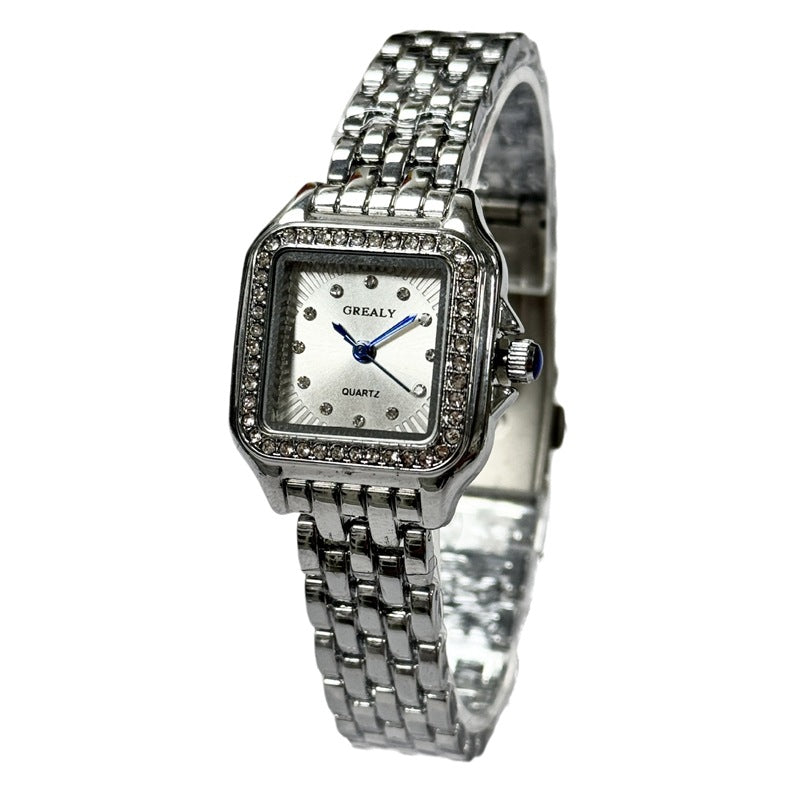Silver watch with a square face on a white background