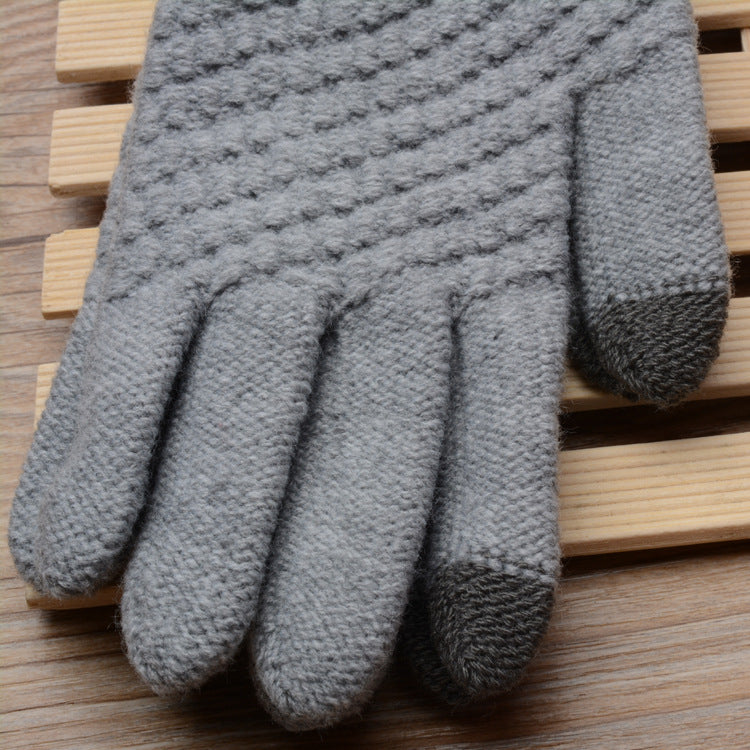 Gray textured glove on a wooden surface