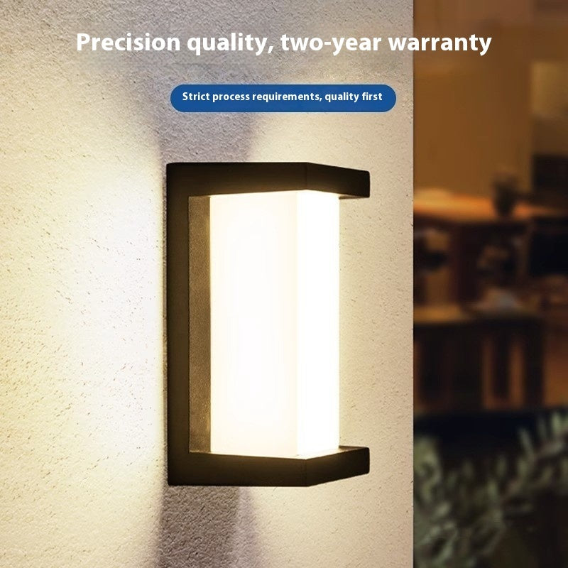 Black outdoor wall sconce with bright white light panel and open rectangular frame