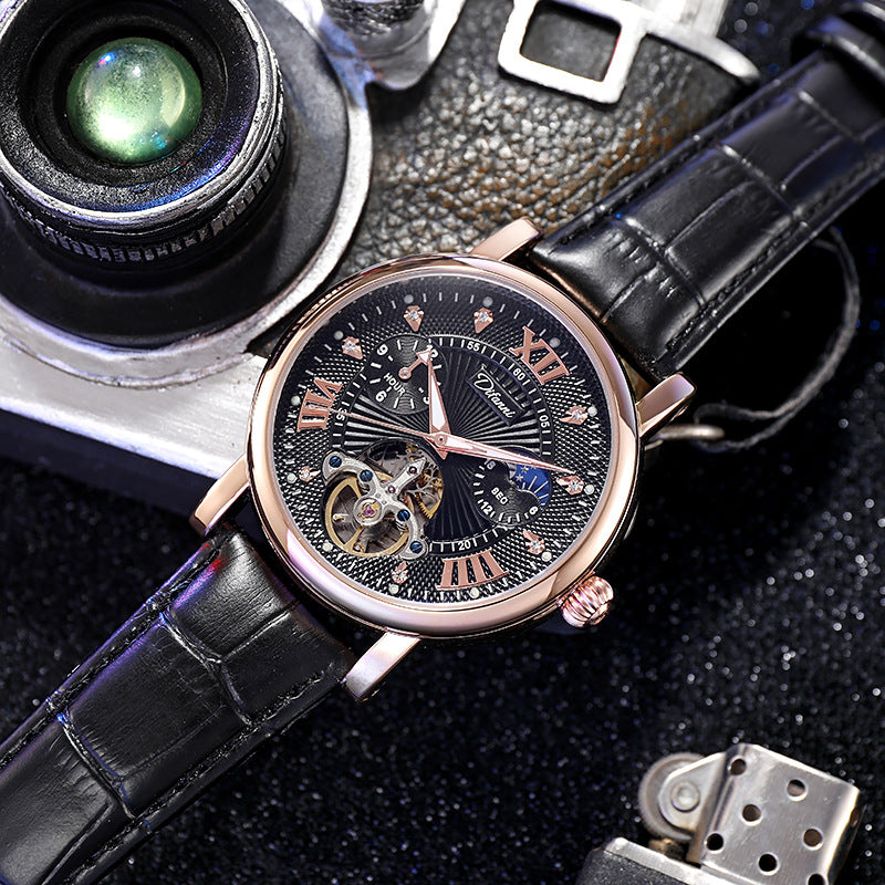 Luxury watch with black leather strap and rose gold case on a dark textured surface.