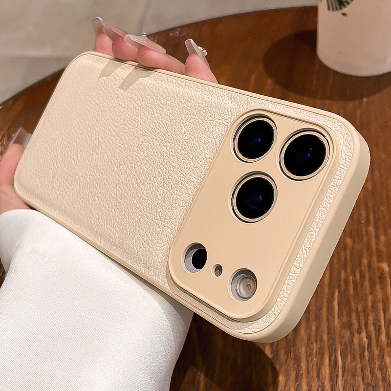 Beige phone case with multiple camera lenses held by a person on a wooden surface.