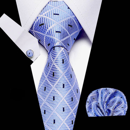Blue patterned tie with matching pocket square on a white shirt background
