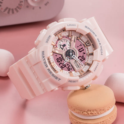 Pink watch with digital and analog display on a pink background with a macaron