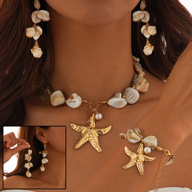 Gold-tone shell bead pendant necklace with a starfish charm centerpiece