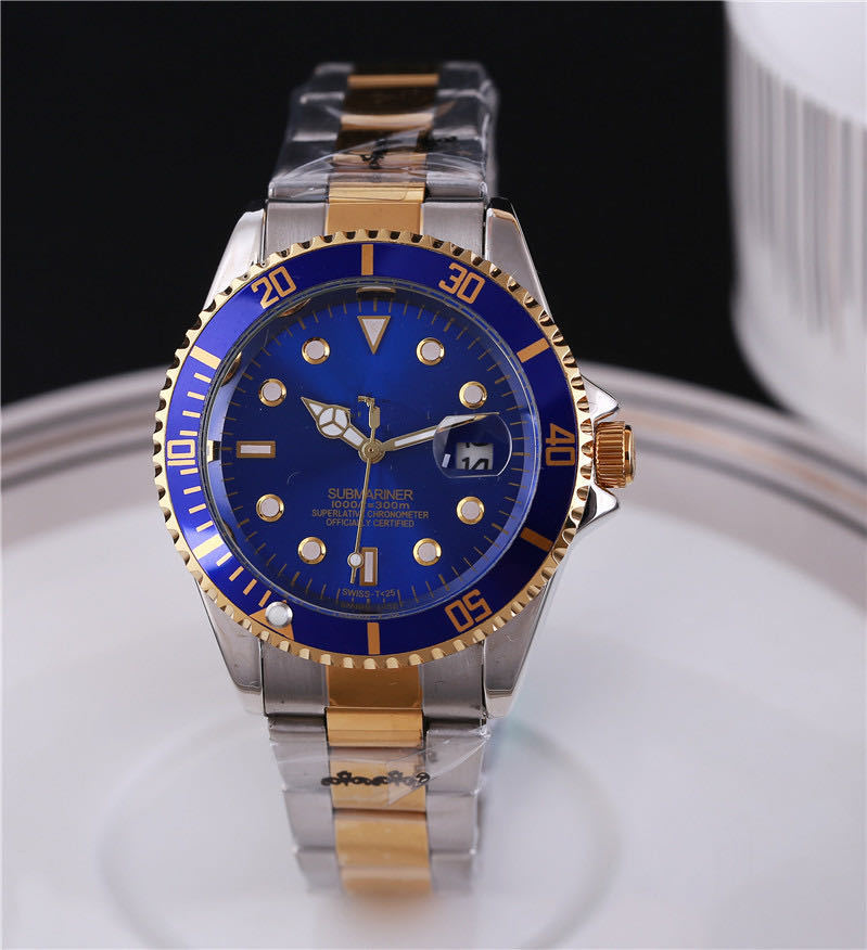 Steel wristwatch with blue dial, stainless bracelet, gold-toned bezel with minute markers.