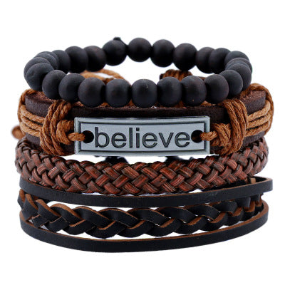 Stack of braided leather and beaded bracelets with a central 'believe' tag on a white background