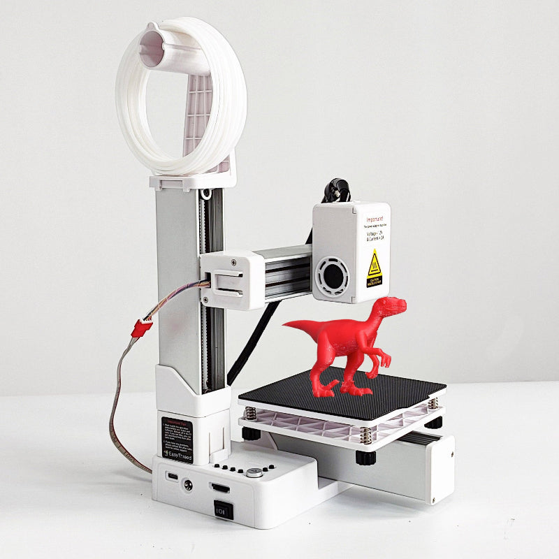 3D printer with a red dinosaur model on a white background
