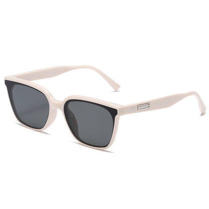 Beige sunglasses with dark lenses on a white background