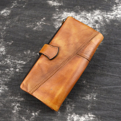 Tan leather long wallet with snap strap and stitched front pocket