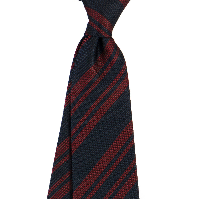Navy and red striped tie on a white background
