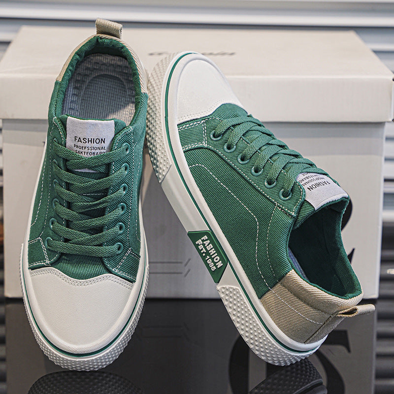 Green sneakers with white soles on a reflective surface