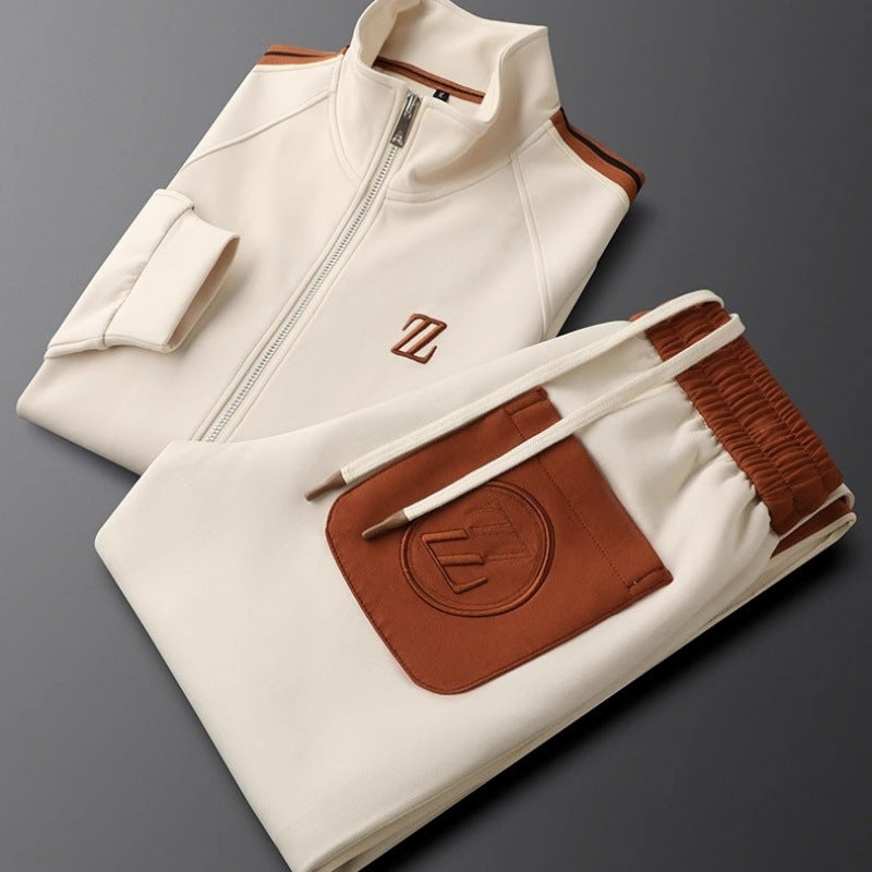Folded cream-colored jacket with brown accents on a gray background