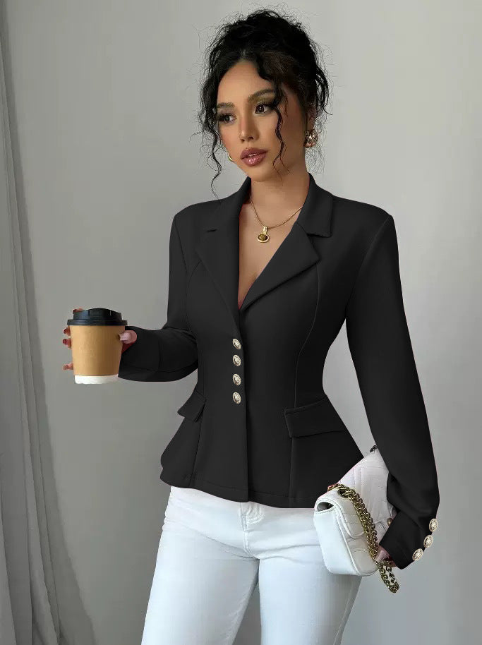 Woman in a black blazer holding a coffee cup against a plain background
