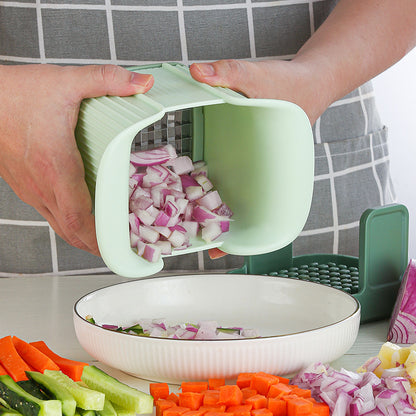 Person using a green vegetable chopper to chop onions, with the chopped onions being transferred into a white bowl.