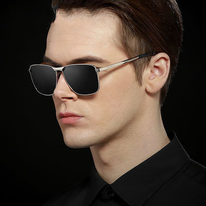 Man wearing black sunglasses against a black background