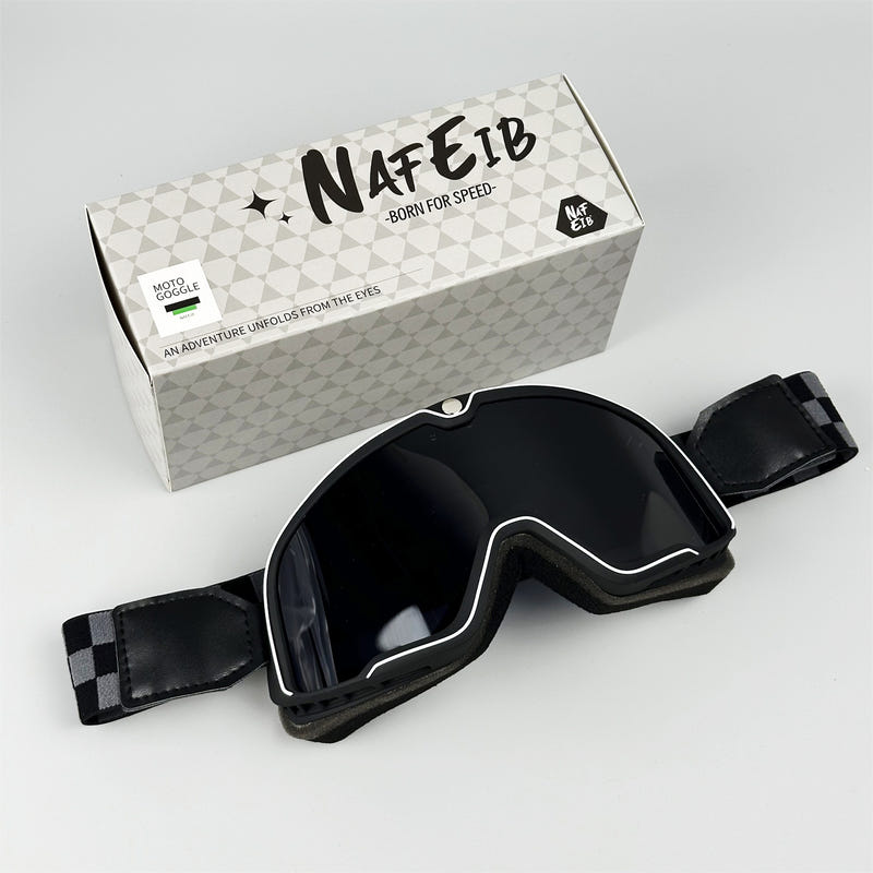 Black motorcycle goggles with dark smoked lens and adjustable strap