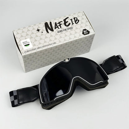 Black motorcycle goggles with dark smoked lens and adjustable strap