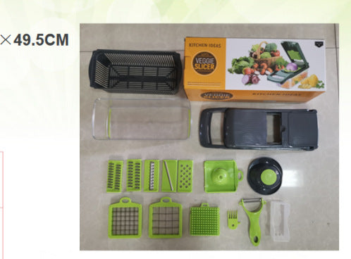 Vegetable cutter slicer kit laid out with box, clear bin, and green accessories