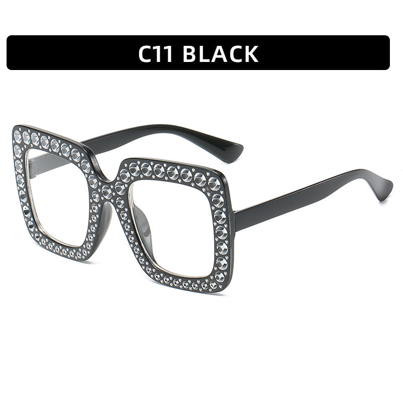 Black cat-eye glasses with rhinestone embellishments on a white background