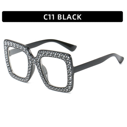 Black cat-eye glasses with rhinestone embellishments on a white background