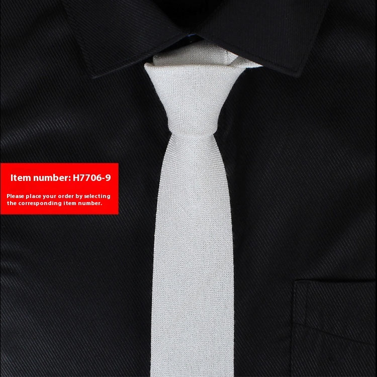 Gray tie on a black suit with a red item number label.