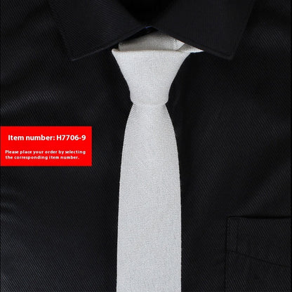 Gray tie on a black suit with a red item number label.