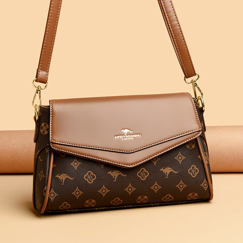 Brown handbag with kangaroo logo on a beige background