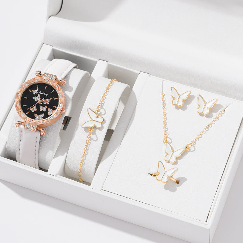Jewelry set with watch, bracelet, and necklace featuring butterfly designs in a white box.