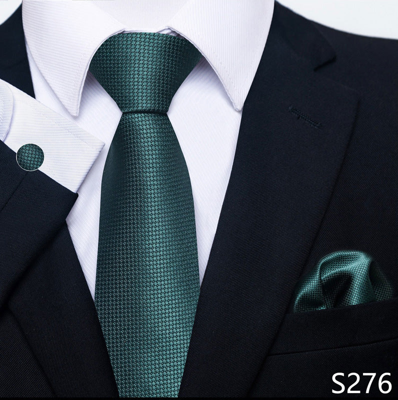 Green tie and pocket square set with a black suit and white shirt