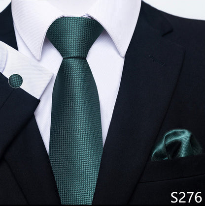 Green tie and pocket square set with a black suit and white shirt