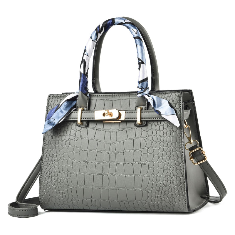 Gray textured handbag with a decorative scarf on a white background