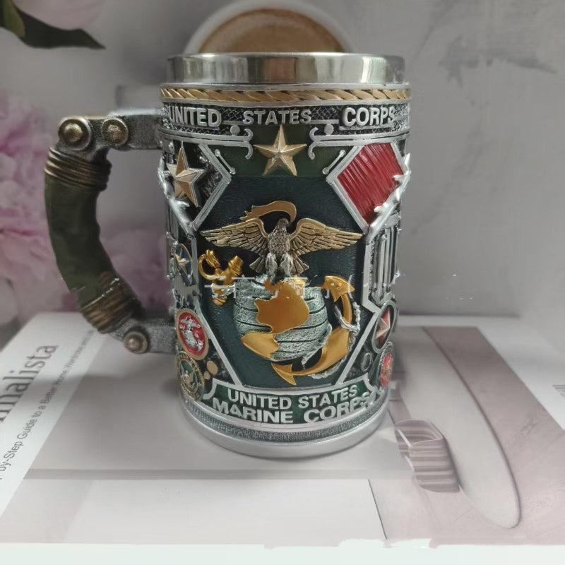 Decorative mug with United States Marine Corps emblem on a surface.