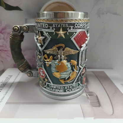 Decorative mug with United States Marine Corps emblem on a surface.