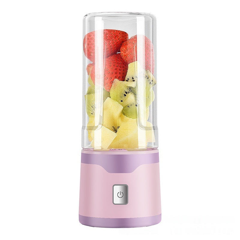 Electric USB juicer cup with clear blending lid, pink base, and fruit inside