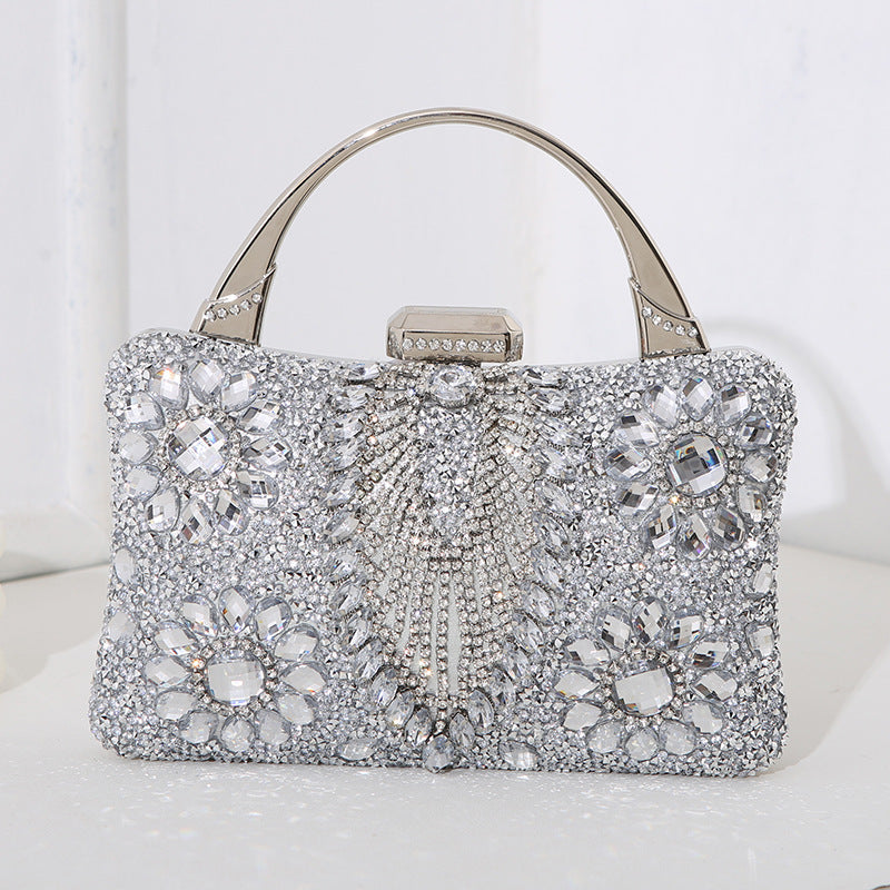 Elegant silver handbag with crystal embellishments on a white background