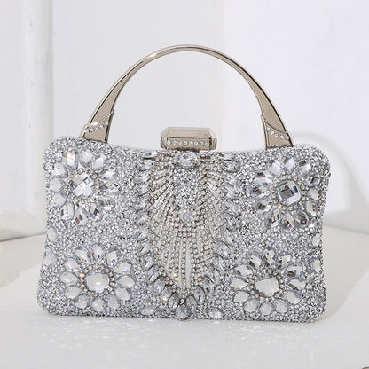 Elegant silver handbag with crystal embellishments on a white background