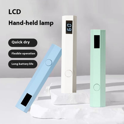 Three nail dryer lamps with LCD displays on a light gray background