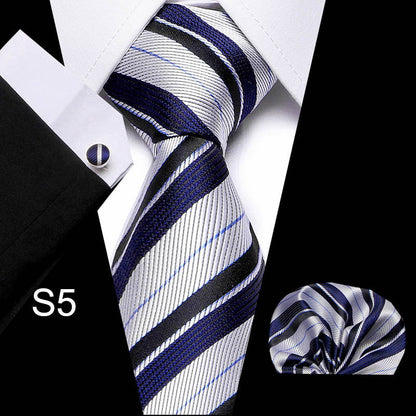 Striped tie with matching pocket square and cufflinks on a black background
