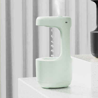 Light green electronic device on a white surface with a gray curtain background