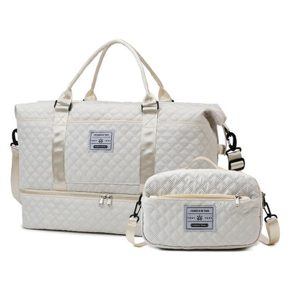 White quilted travel bag with zip compartment and matching crossbody pouch