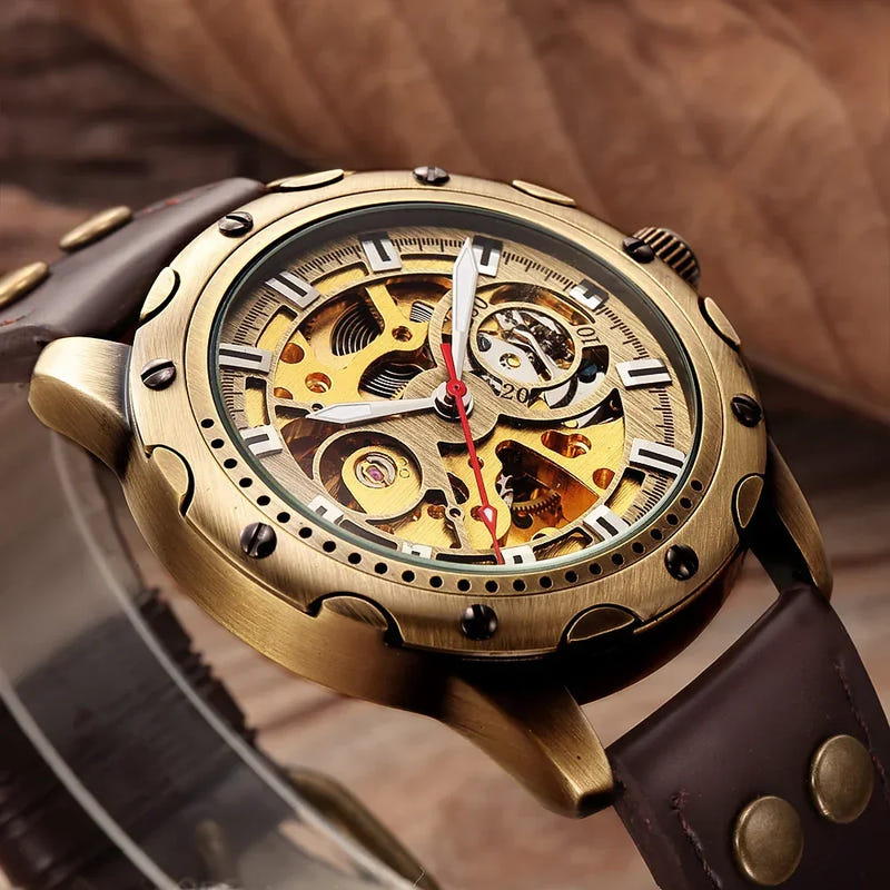 Bronze-tone automatic skeleton watch with gold open-work dial and dark brown leather strap