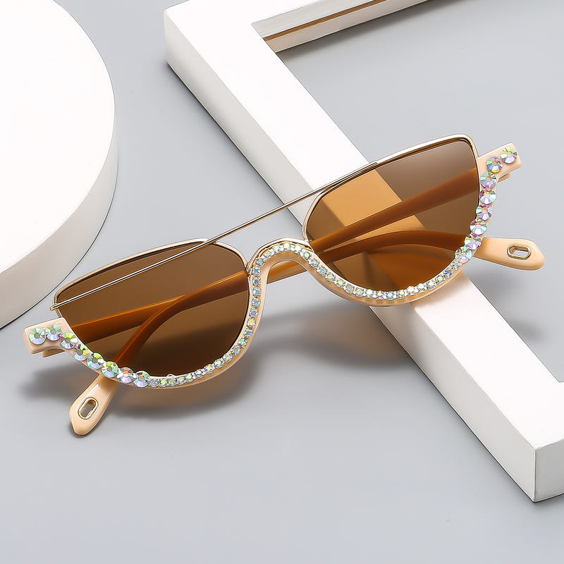 Cat-eye sunglasses with gold frame, amber tinted lenses, and multicolor rhinestone trim