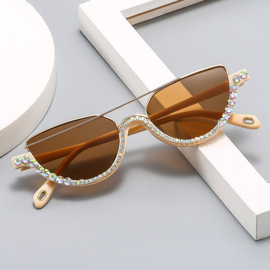 Cat-eye sunglasses with gold frame, amber tinted lenses, and multicolor rhinestone trim