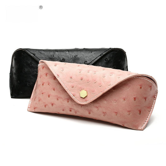 Black and pink textured clutch bags on a white background