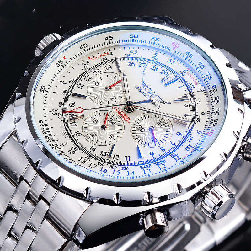 White dial chronograph watch with blue tachymeter markings, silver link bracelet