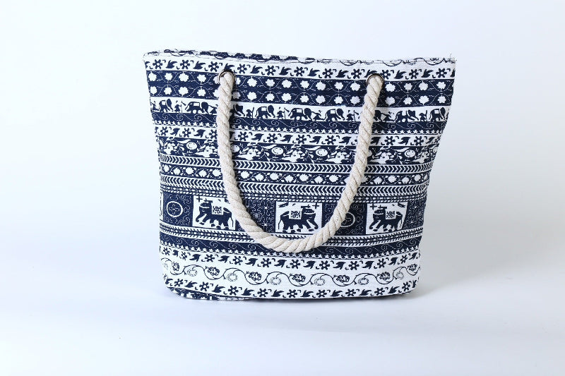 Navy blue tote bag with white patterns on a white background