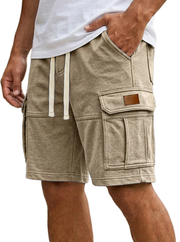 Beige cargo shorts worn by a person on a white background