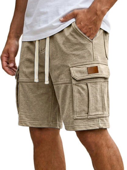 Beige cargo shorts worn by a person on a white background