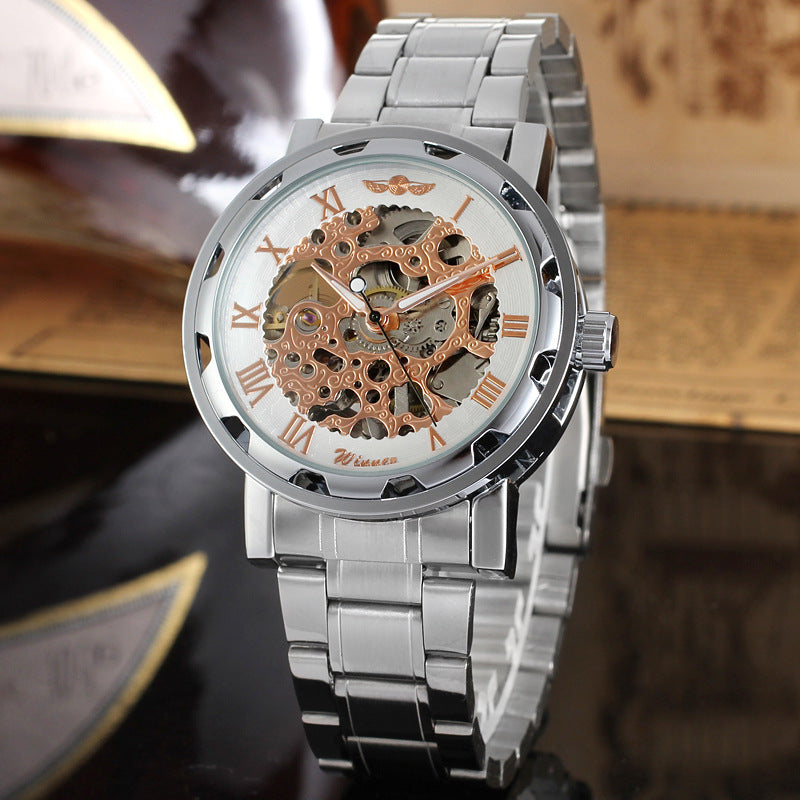 Silver wristwatch with mechanical gears on a dark surface
